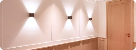 Flur mit Wandleuchten und Holzvertäfelung nach der Renovierung