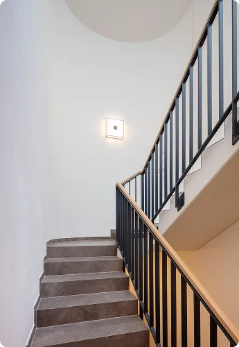 Renoviertes Treppenhaus mit Wandleuchte